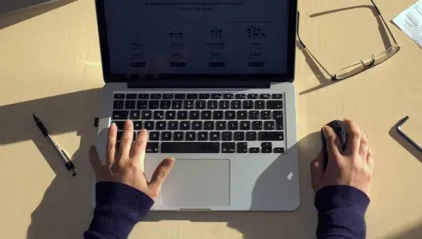 User hands using a laptop